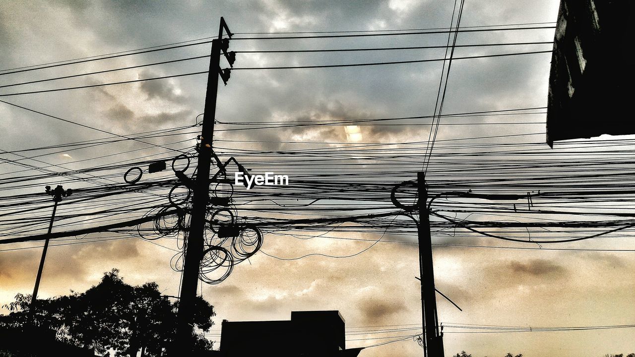 Low angle view of electricity pylon against sky