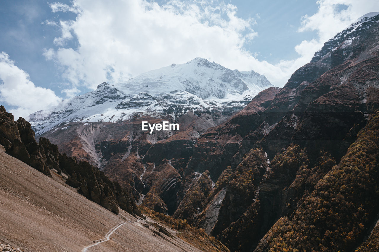 panoramic view of snowcapped mountains against sky
