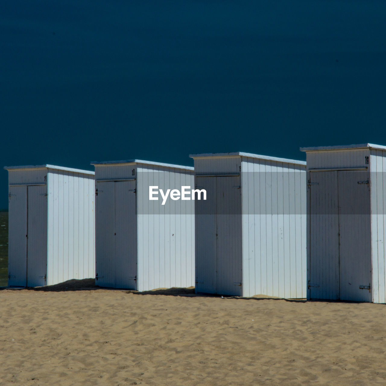 Structure on sand with sky in background