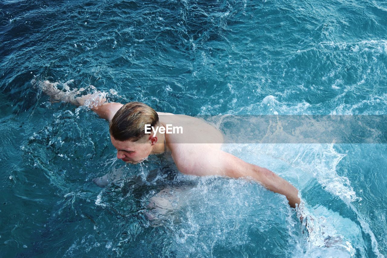 High angle view of man swimming in sea