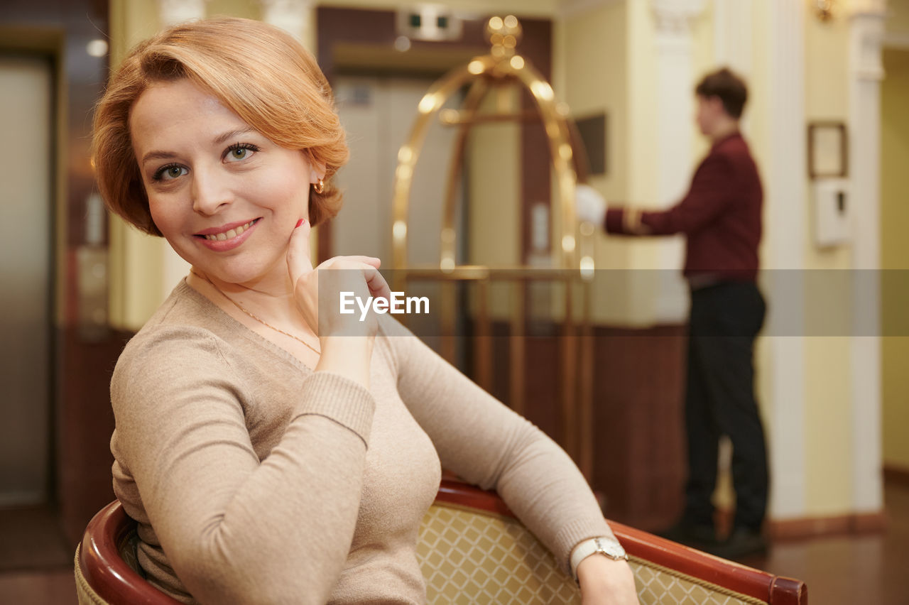 Beautiful woman sitting in hotel