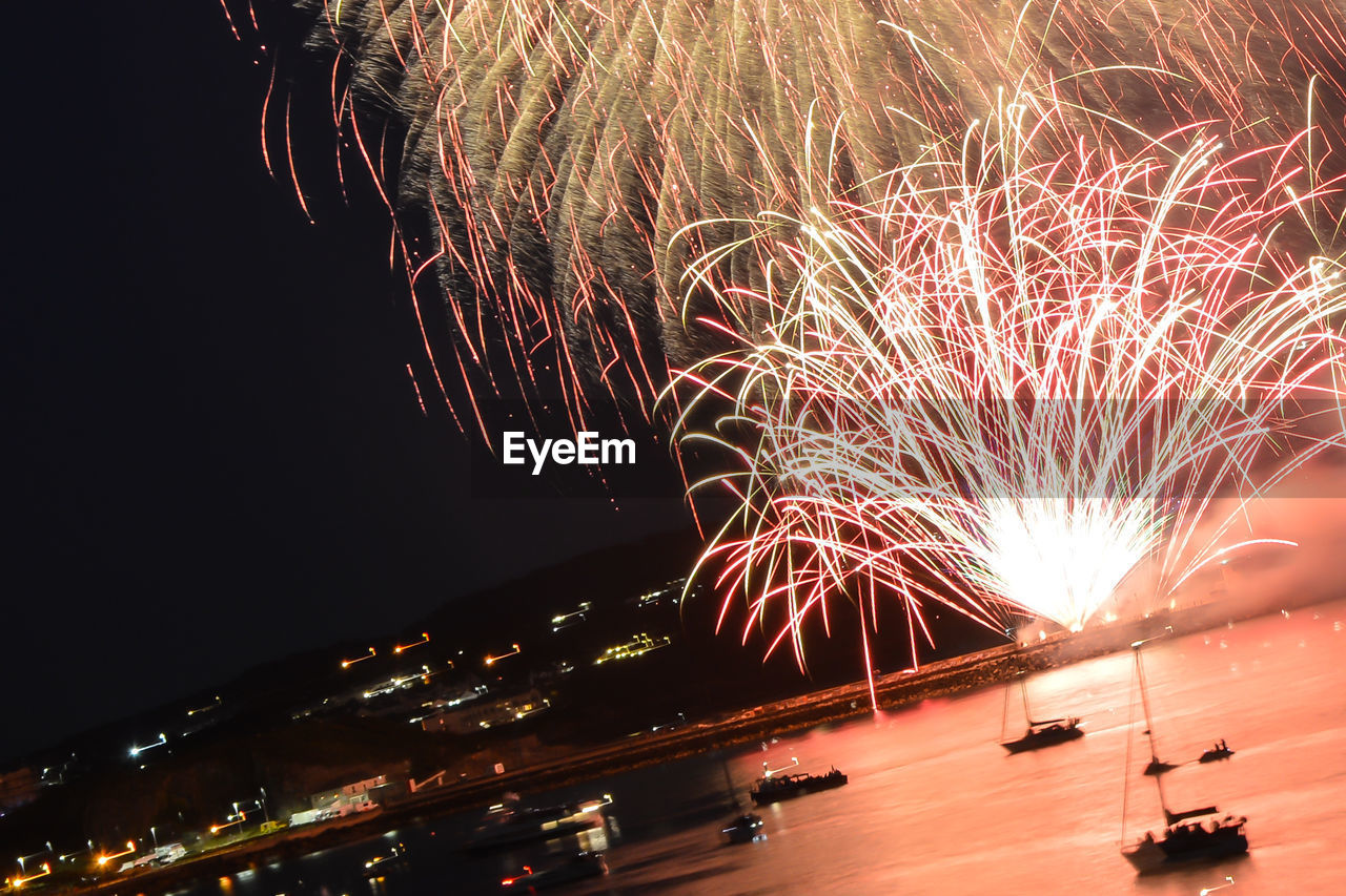 Tilt shot of firework display at night