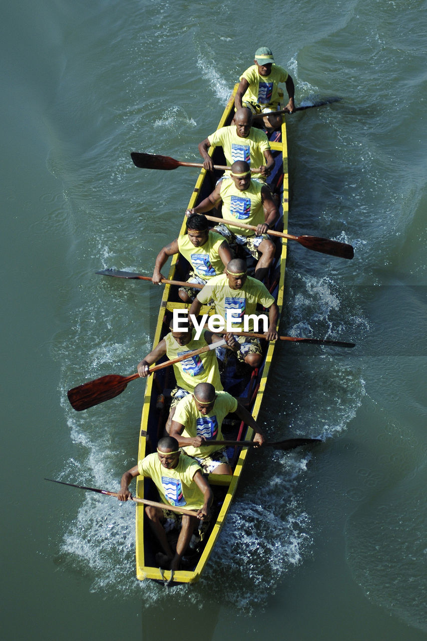 HIGH ANGLE VIEW OF PEOPLE IN BOAT AT WATER
