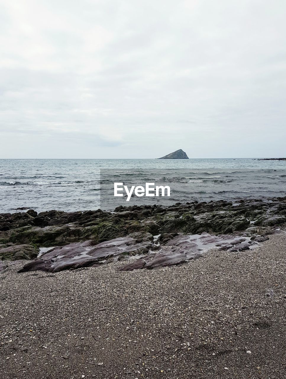 SCENIC VIEW OF SHORE AGAINST SKY