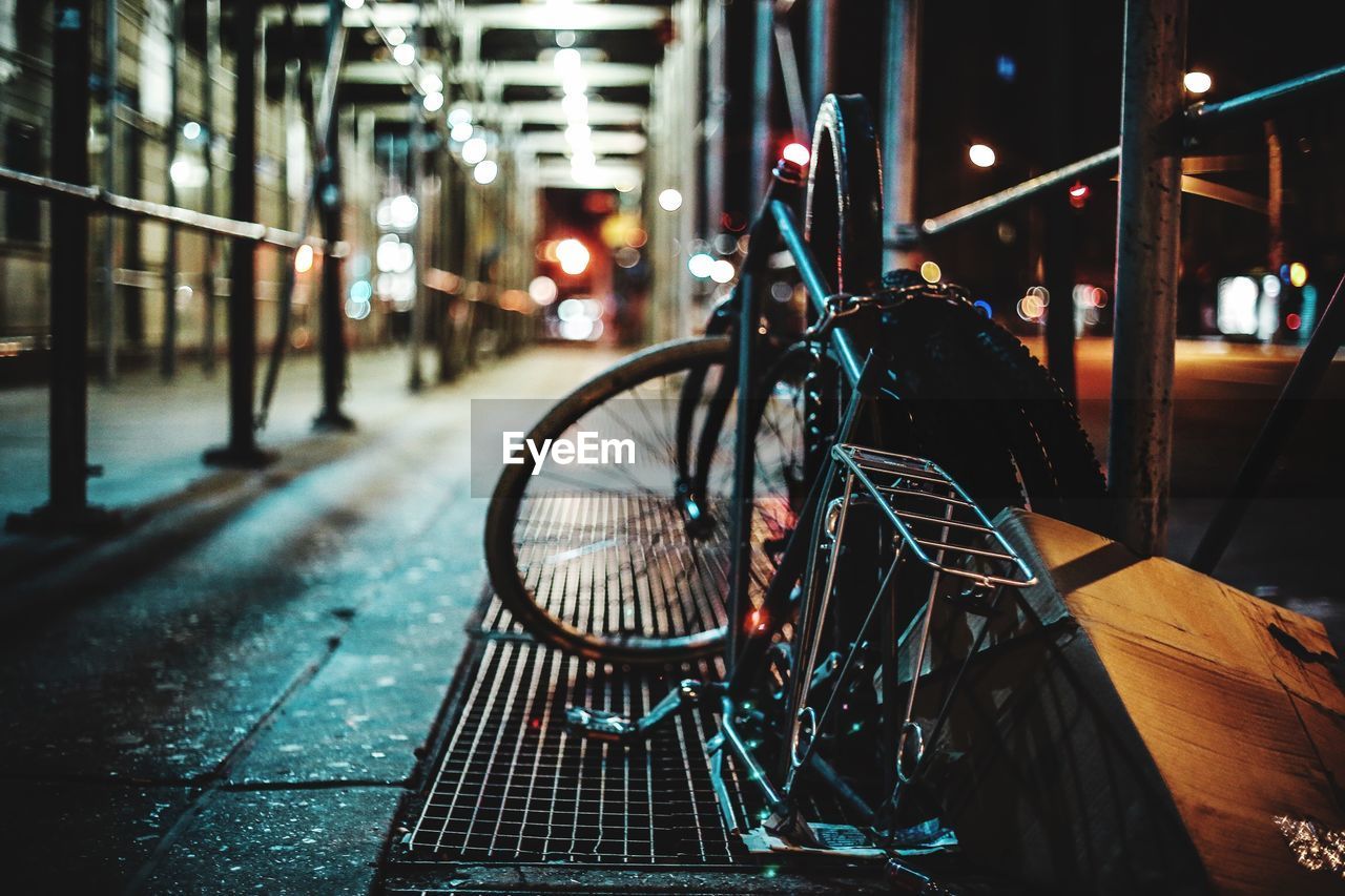 Abandoned bicycle on bench at night