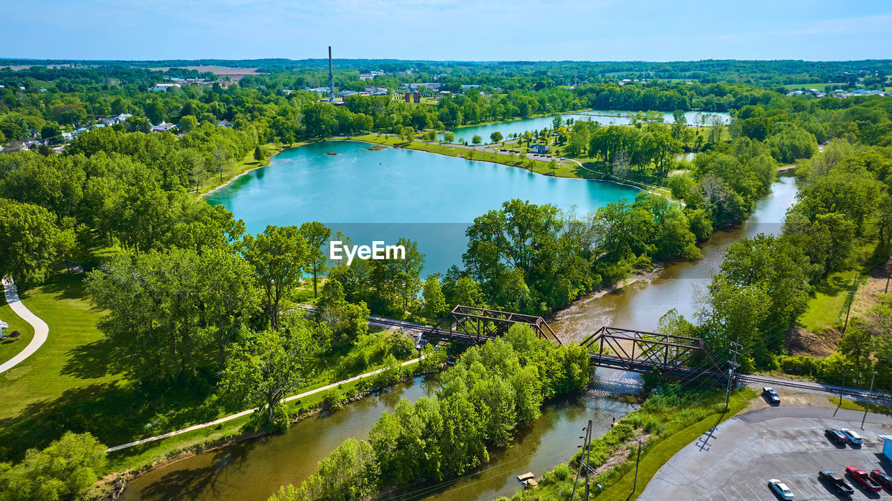 high angle view of river amidst trees in city