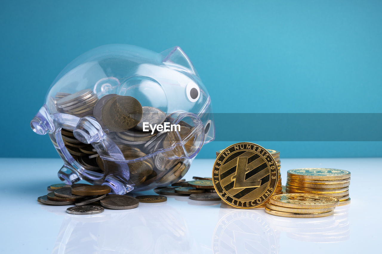 CLOSE-UP OF COINS ON BLUE TABLE