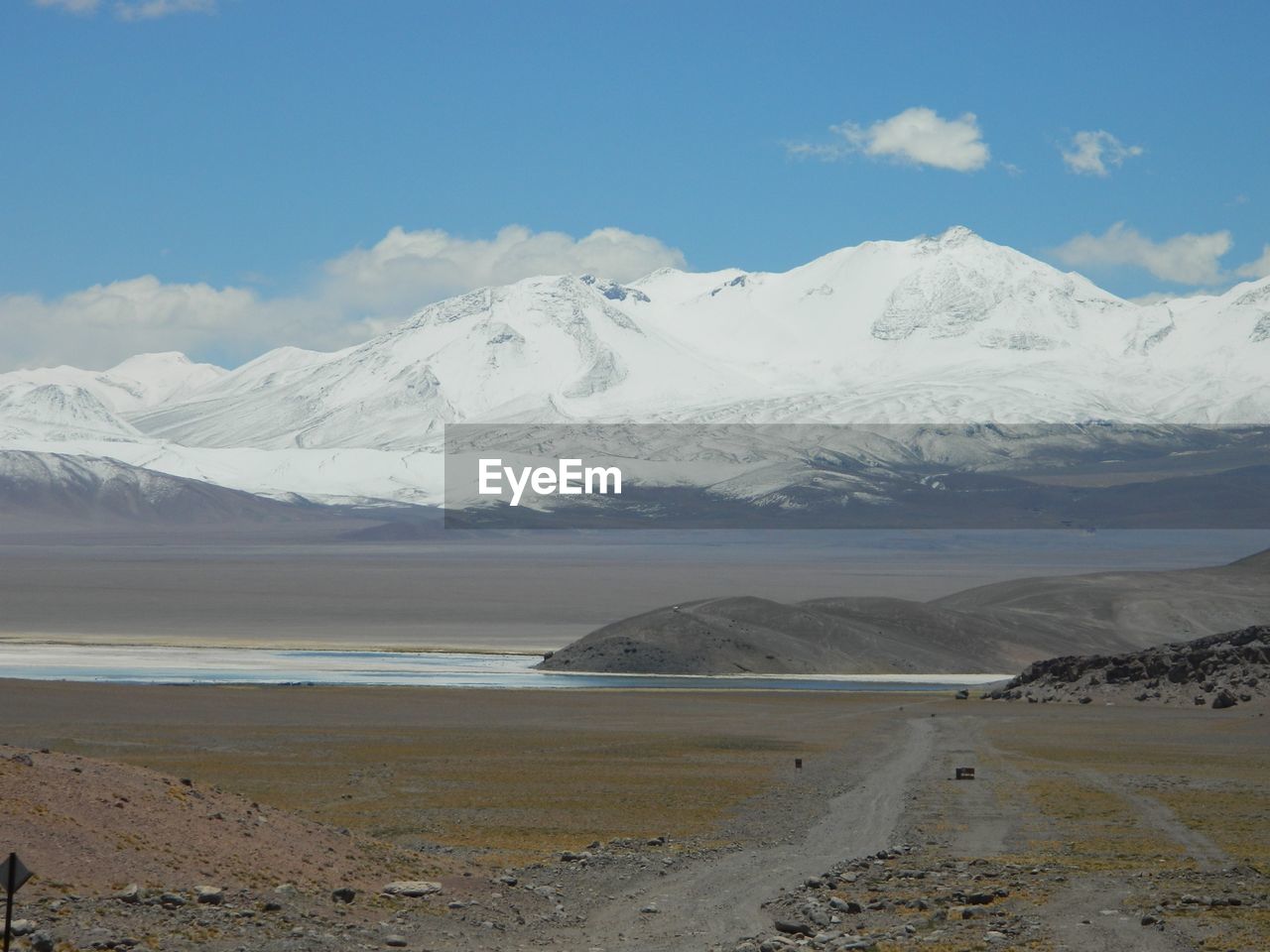 scenic view of snowcapped mountains against blue sky