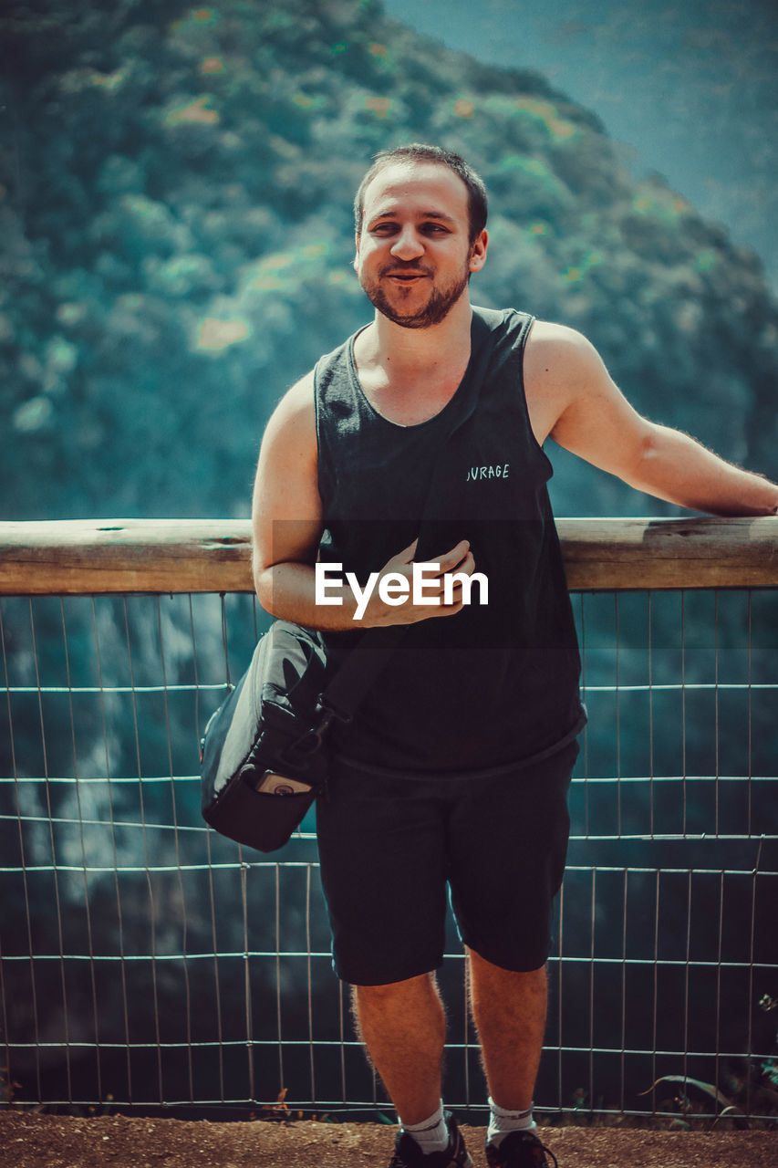 Portrait of smiling young man standing outdoors