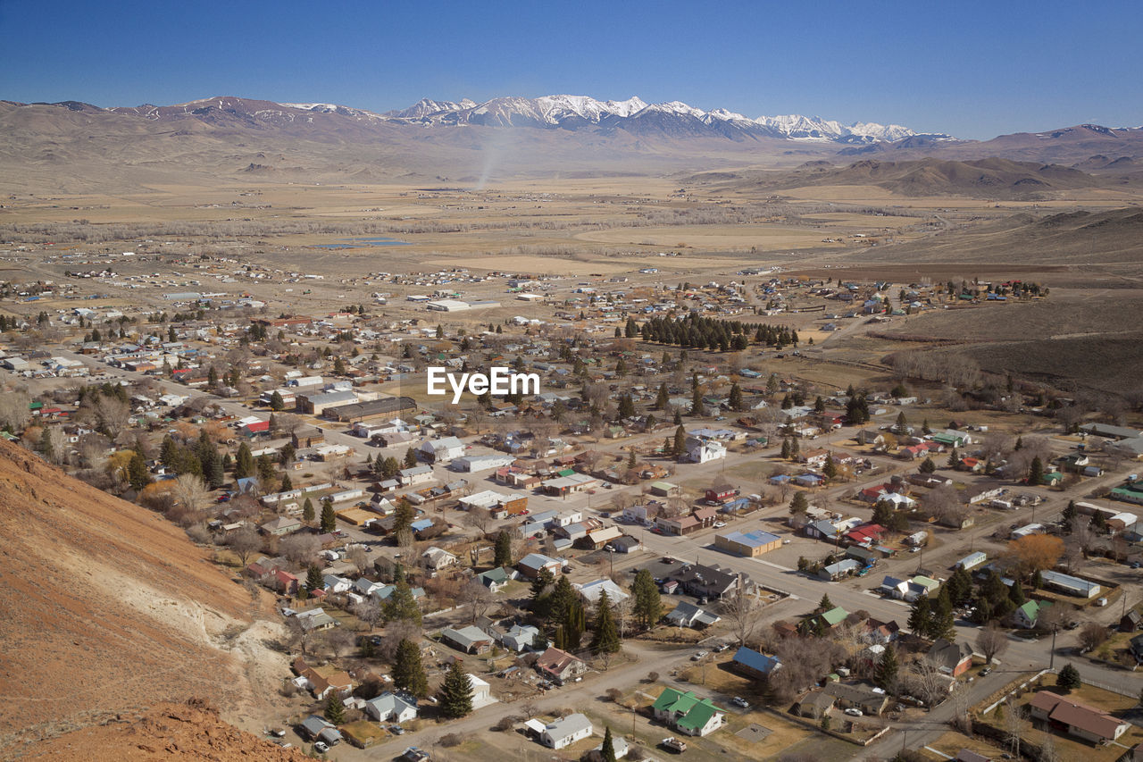 High angle view of townscape against snowcapped mountains