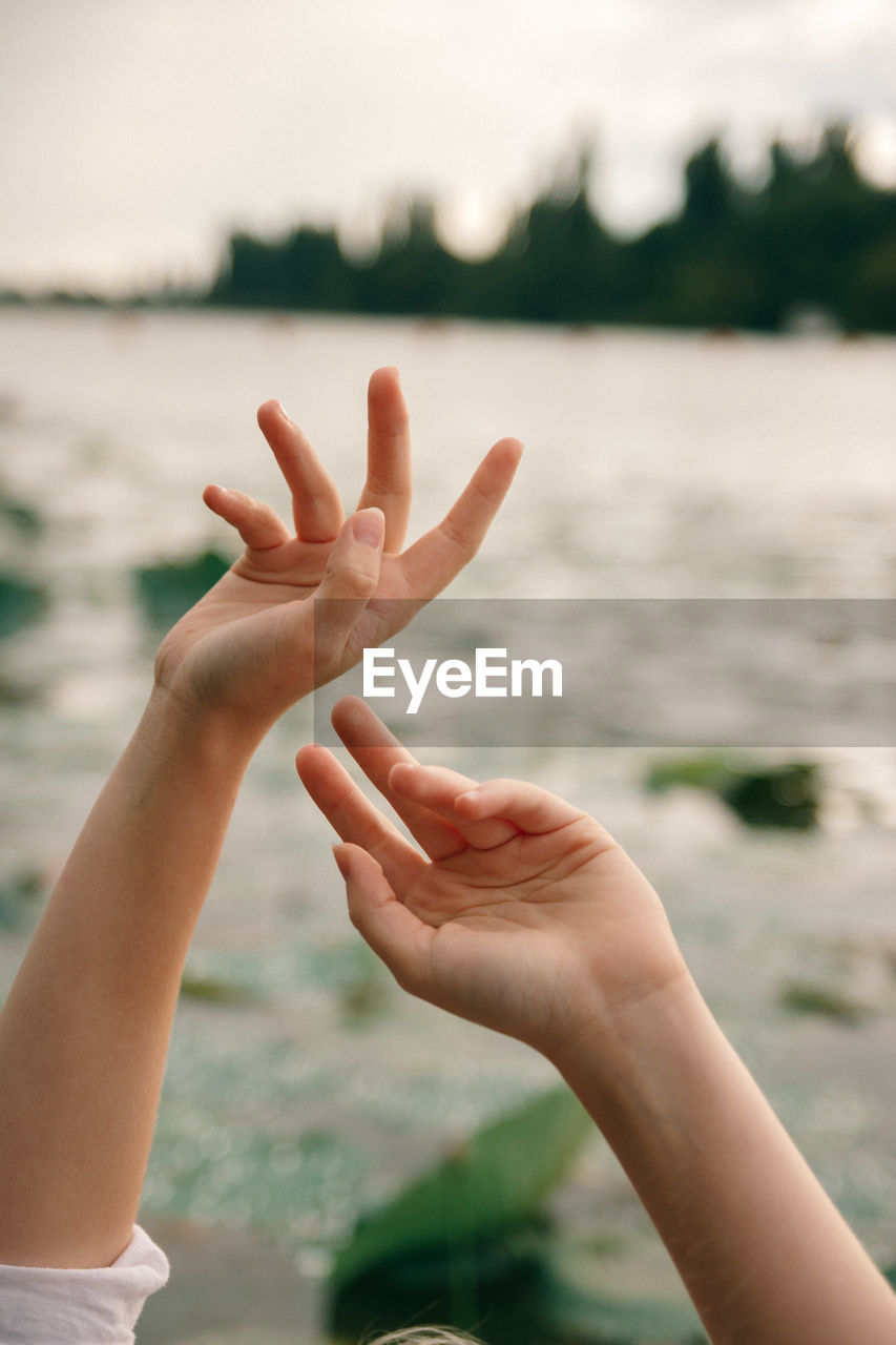 Cropped image of woman hand against blurred background