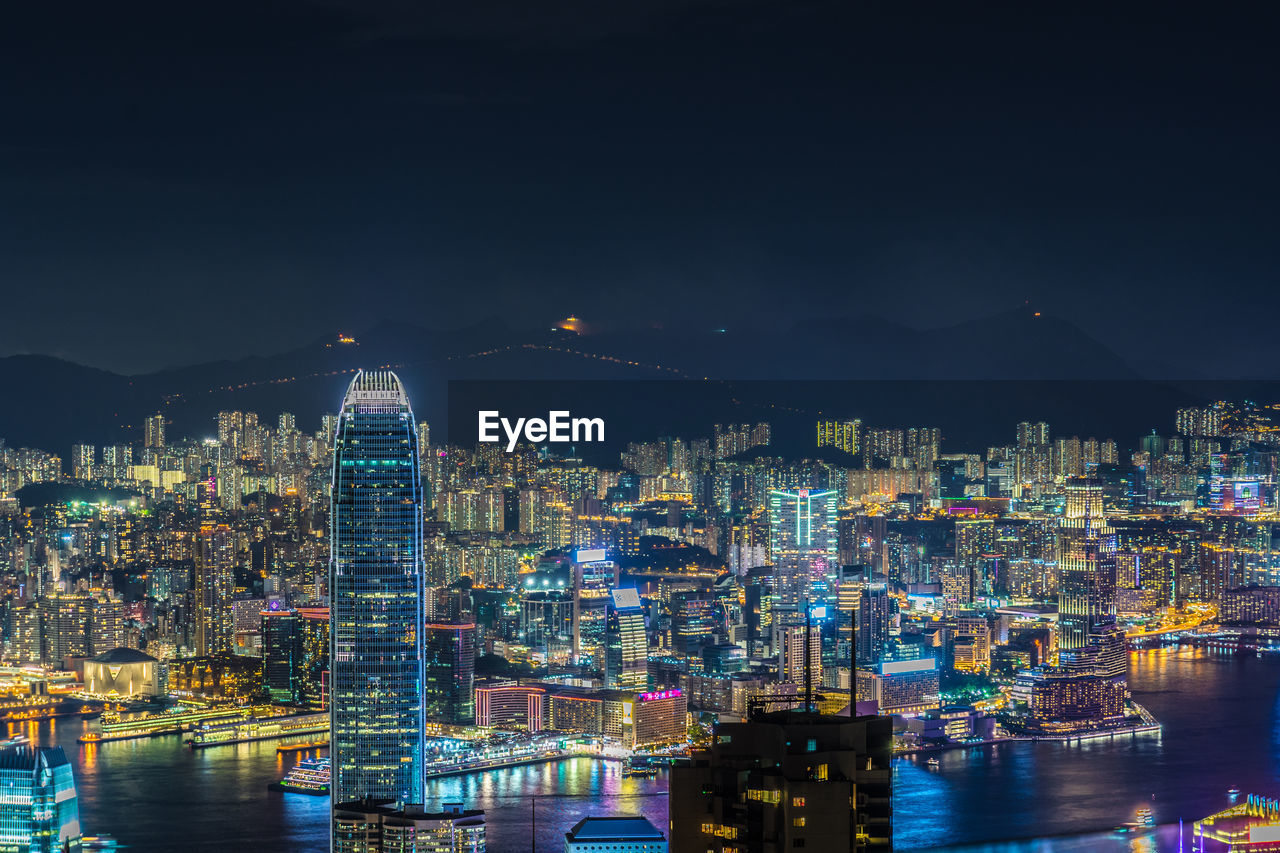 ILLUMINATED CITY BUILDINGS AGAINST SKY