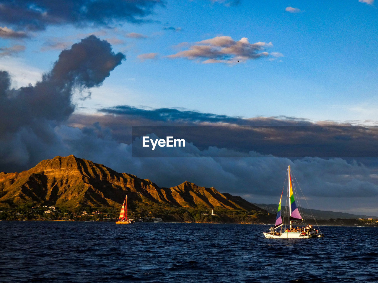 SAILBOATS SAILING IN SEA AGAINST SKY