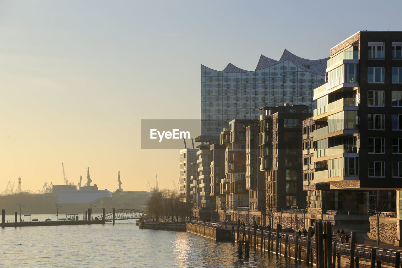 Hafencity silhouette with elbphilharmonie, harbor and elbe river at dusk