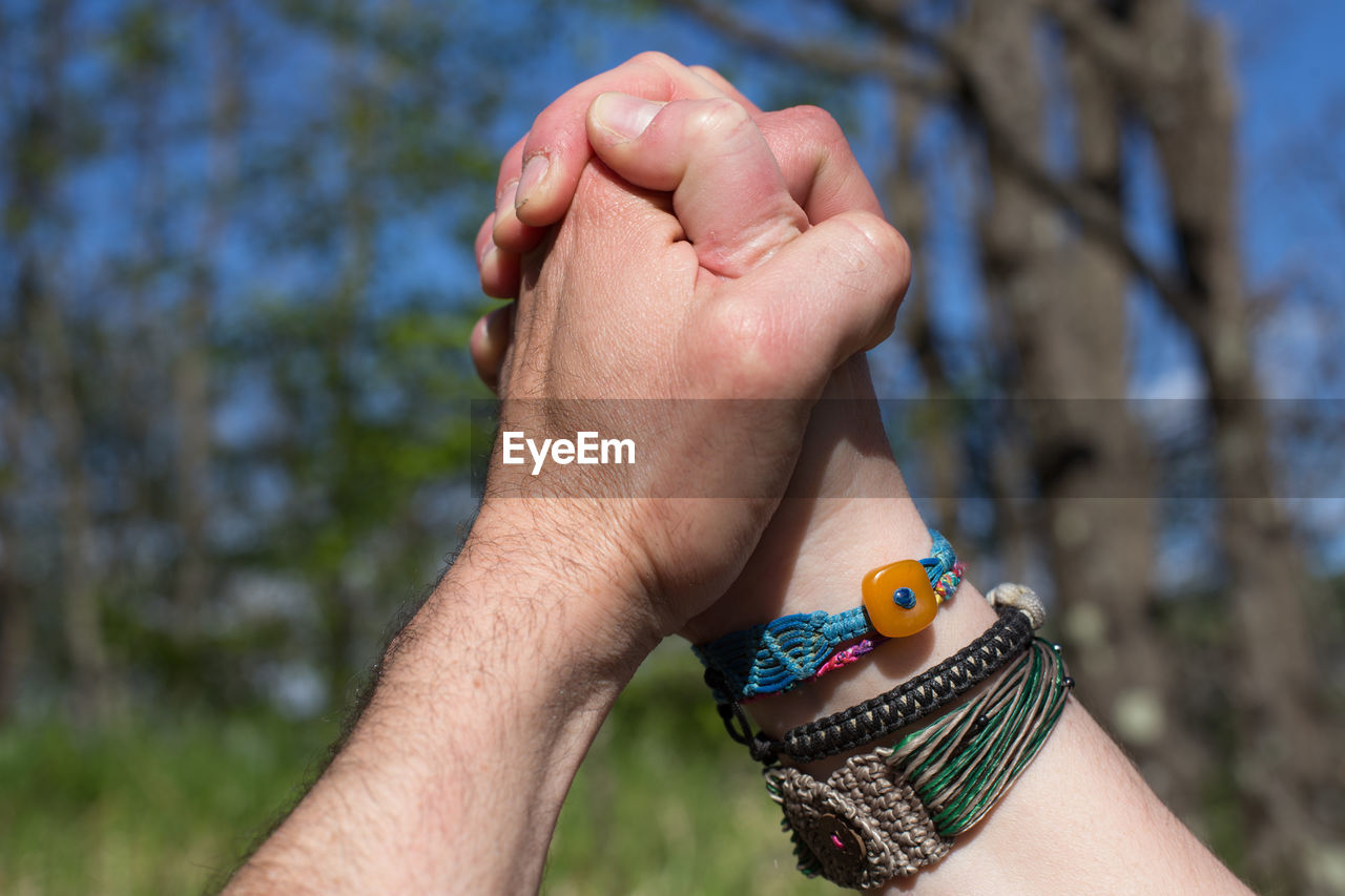 Cropped image of people holding hands