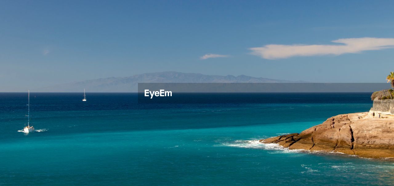 Scenic view of sea against blue sky