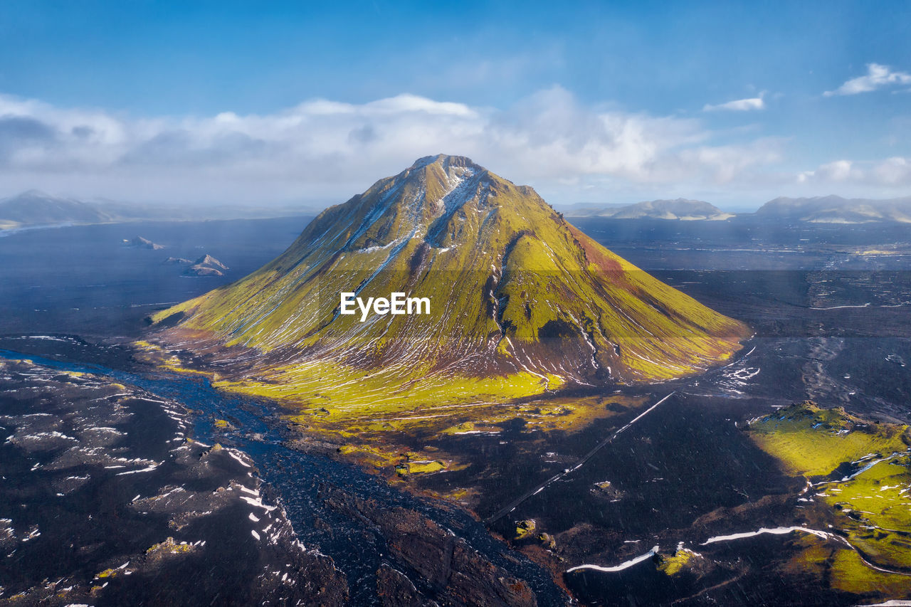 Scenic view of volcanic mountain against sky