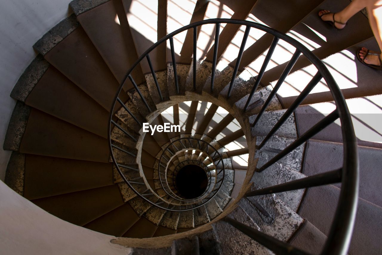 spiral, steps and staircases, spiral staircase, staircase, architecture, railing, built structure, indoors, diminishing perspective, design, high angle view, pattern, day, no people, absence, directly above, shape, metal, geometric shape, circle, directly below