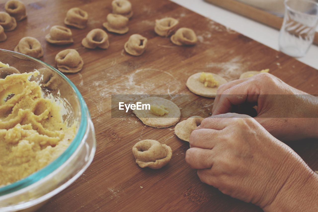 Cropped image of person preparing ravioli pasta