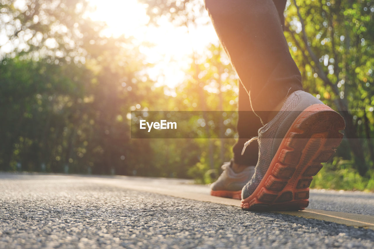 Woman running on nature at autumn morning, healthy lifestyle concept.