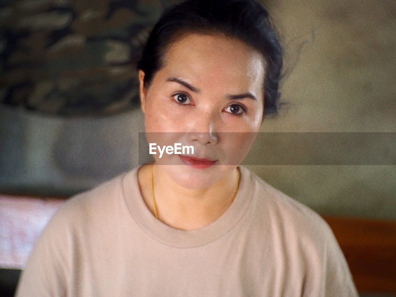 Portrait of a smiling young woman at home