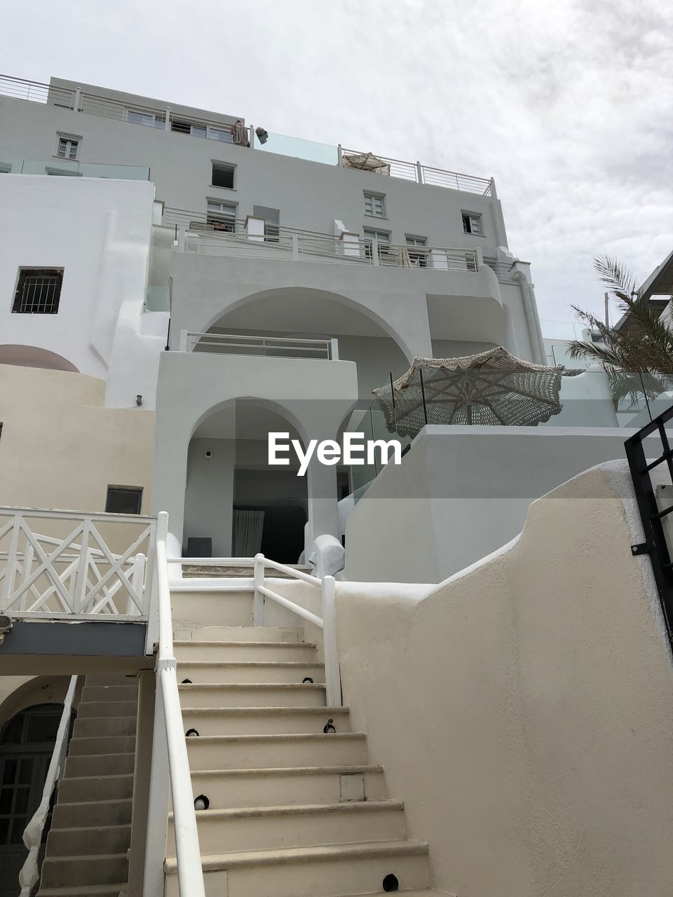 LOW ANGLE VIEW OF STAIRCASE AGAINST BUILDINGS