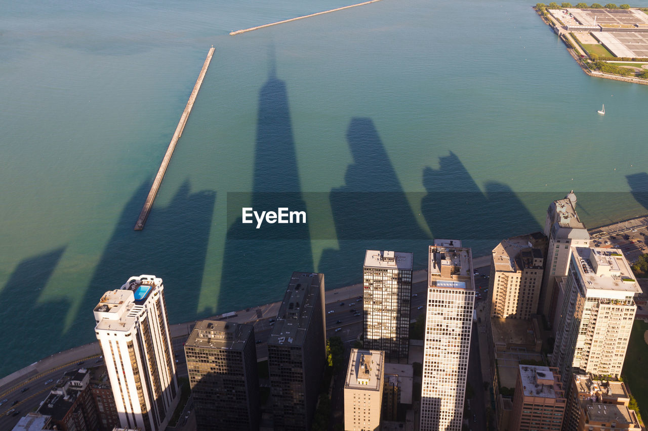 High angle view of skyscrapers in city against sea