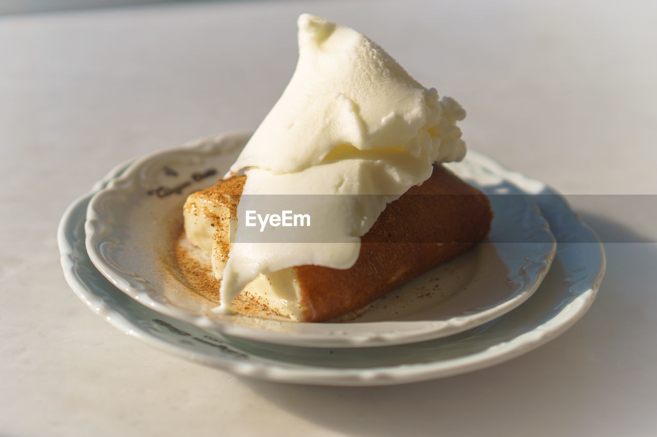 Bread with vanilla ice cream on plate