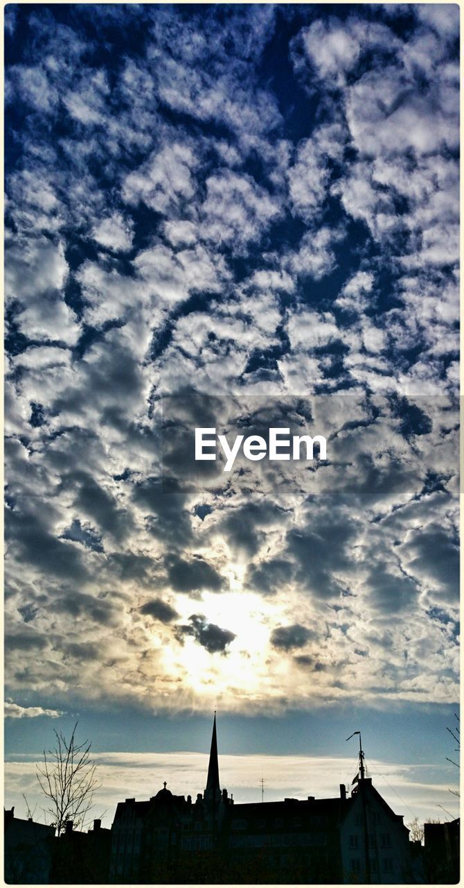 Silhouette buildings against sky at sunset