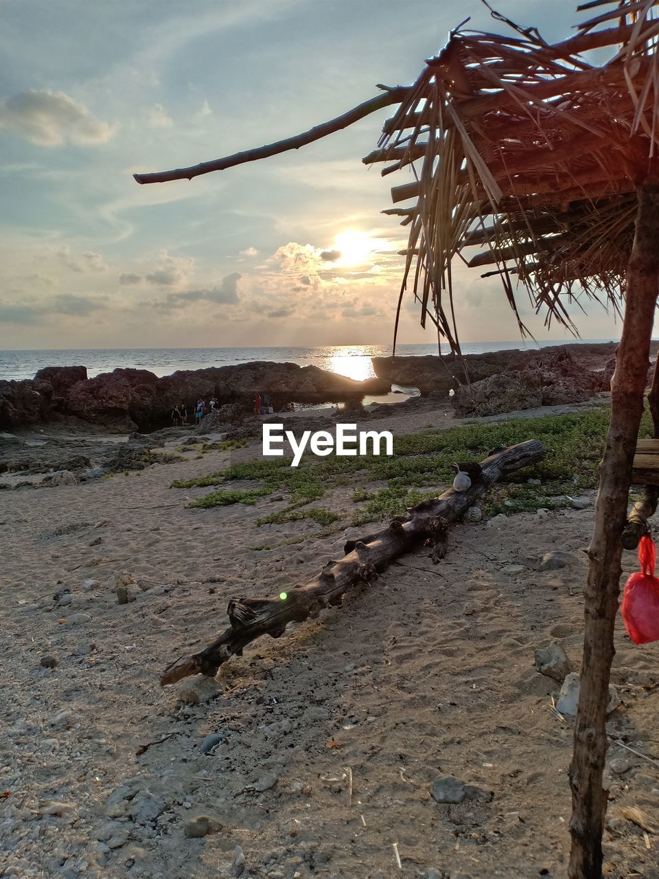 SCENIC VIEW OF BEACH DURING SUNSET