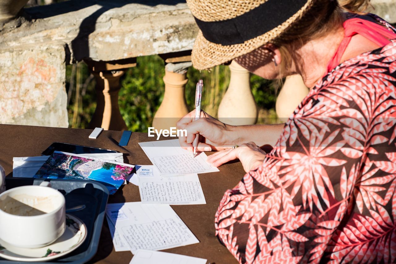 Woman writing postcards