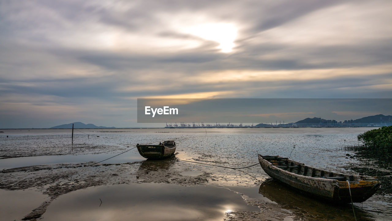 water, sky, cloud, nautical vessel, transportation, reflection, sea, nature, morning, mode of transportation, scenics - nature, beauty in nature, shore, tranquility, beach, land, no people, tranquil scene, vehicle, travel, ocean, boat, outdoors, travel destinations, coast, ship, moored, environment, wave, landscape, dusk, dramatic sky, idyllic, non-urban scene, sunlight, architecture, day