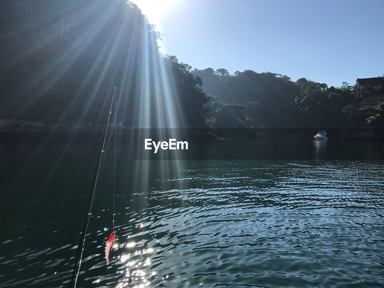 MAN IN WATER AGAINST SKY