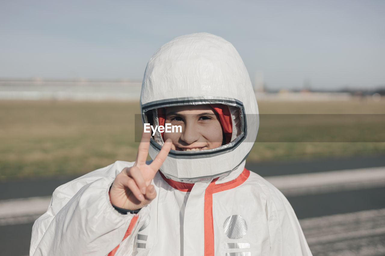 Portrait of smiling girl in astronaut costume, empowered girl concept, international women's day