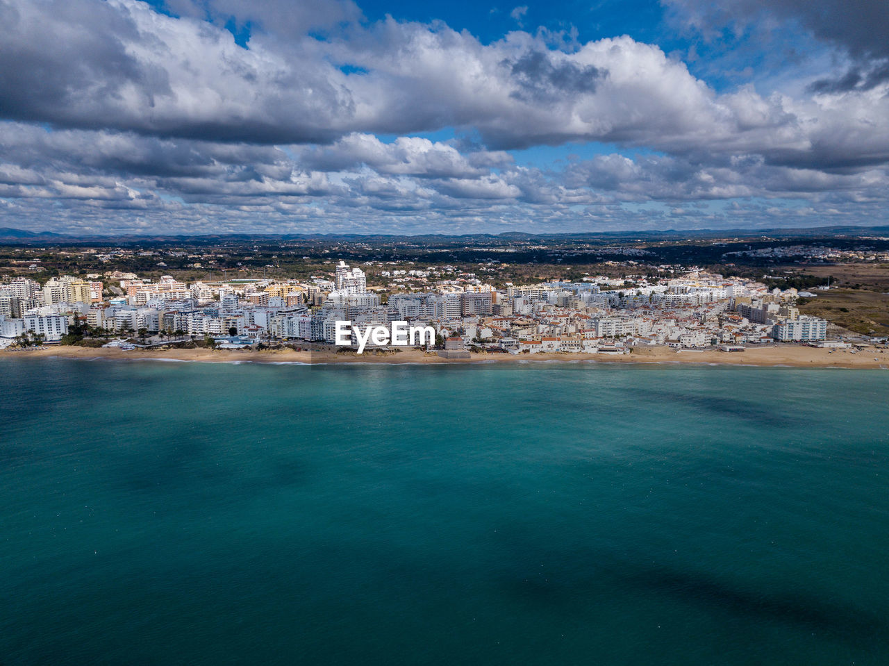 Scenic view of sea and buildings against sky