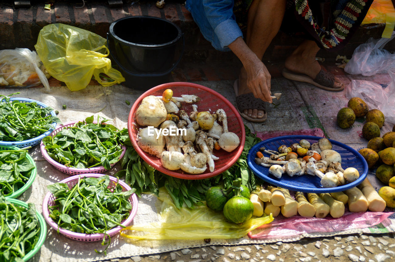 High angle view of a vendor selling exotic vegetables and mushroom at market