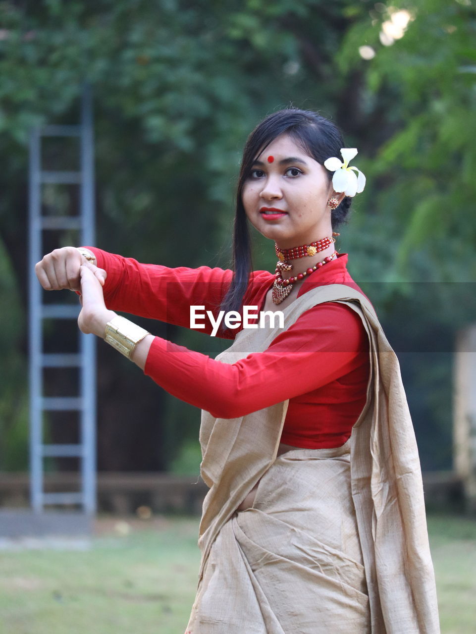 Portrait of young woman in traditional clothing standing outdoors