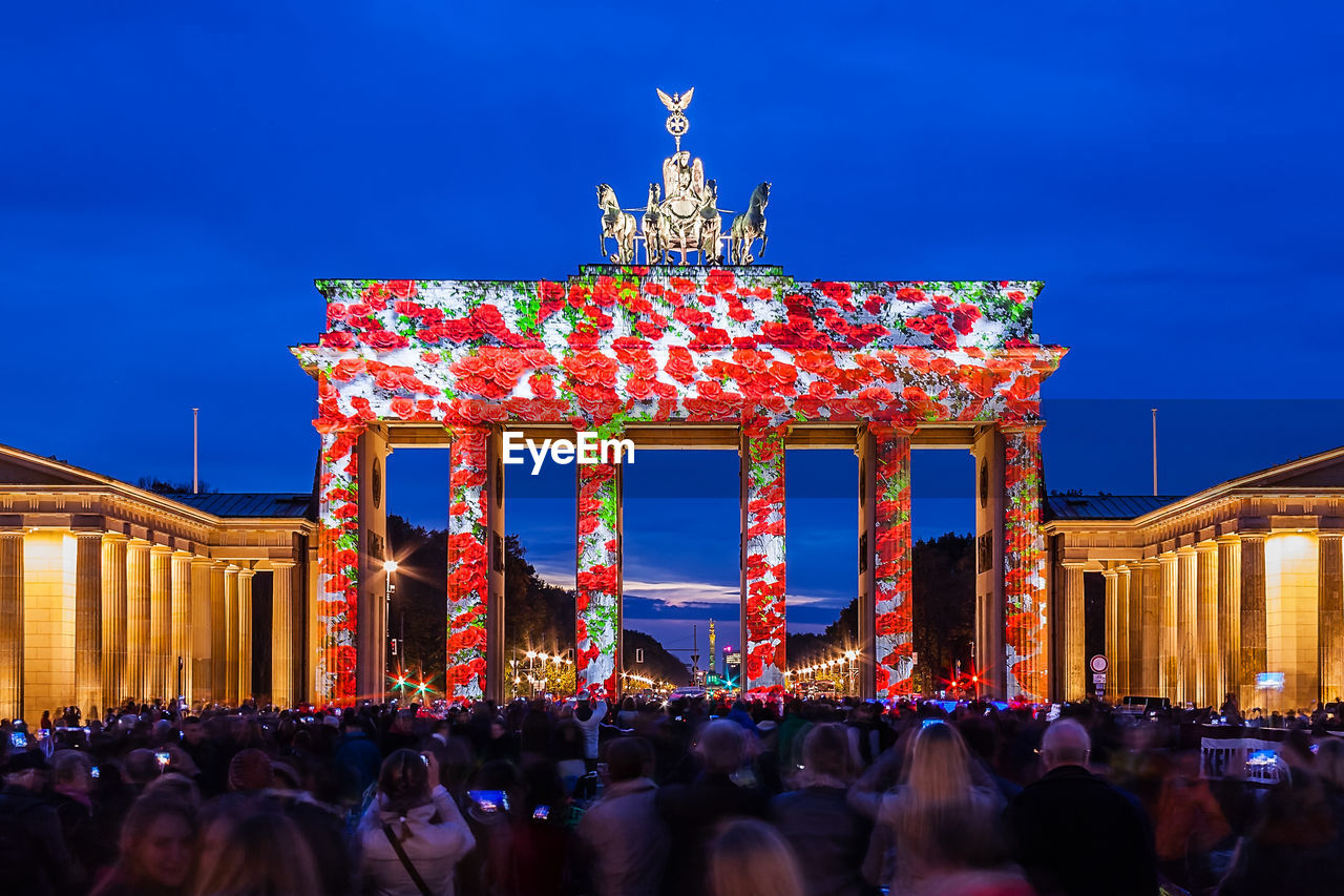 CROWD IN ILLUMINATED BUILDING