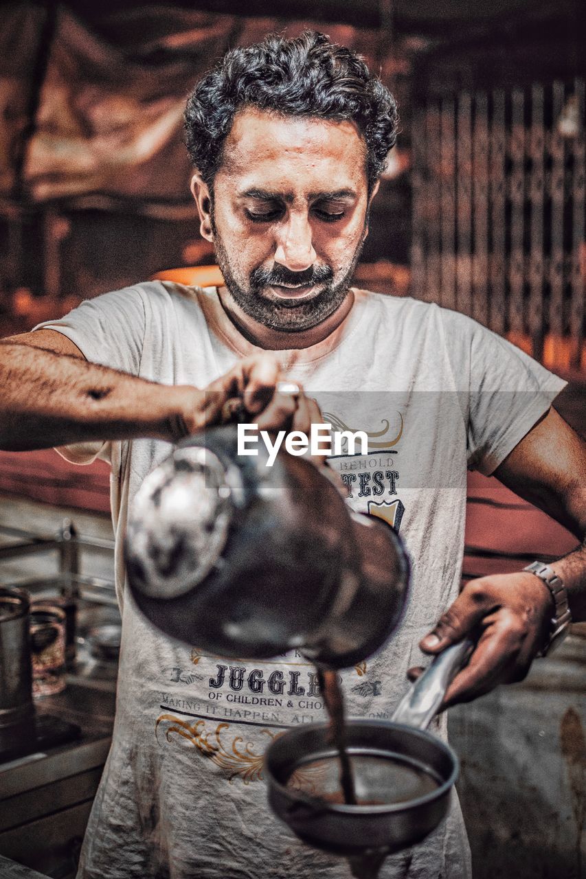 Man pouring tea at market