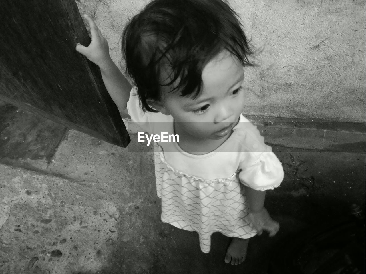 High angle view of girl standing against wall