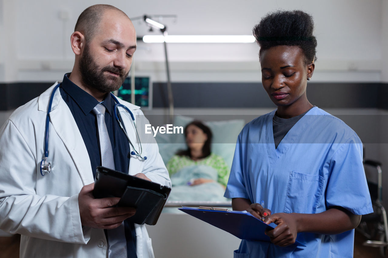 Doctor and nurse having discussion at clinic