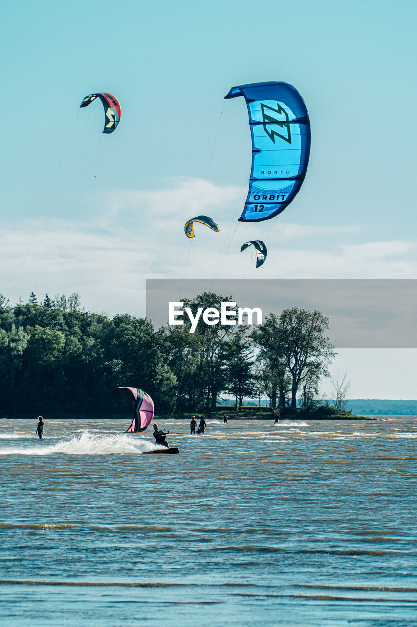 People enjoying in sea against sky