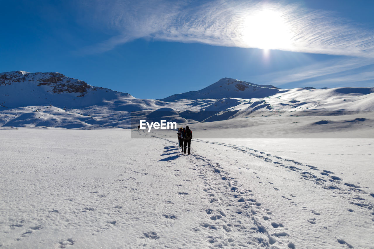 People skiing on snowcapped mountain