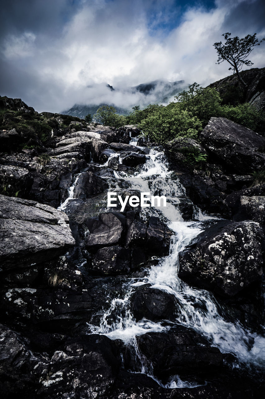 Scenic view of stream flowing through rocks