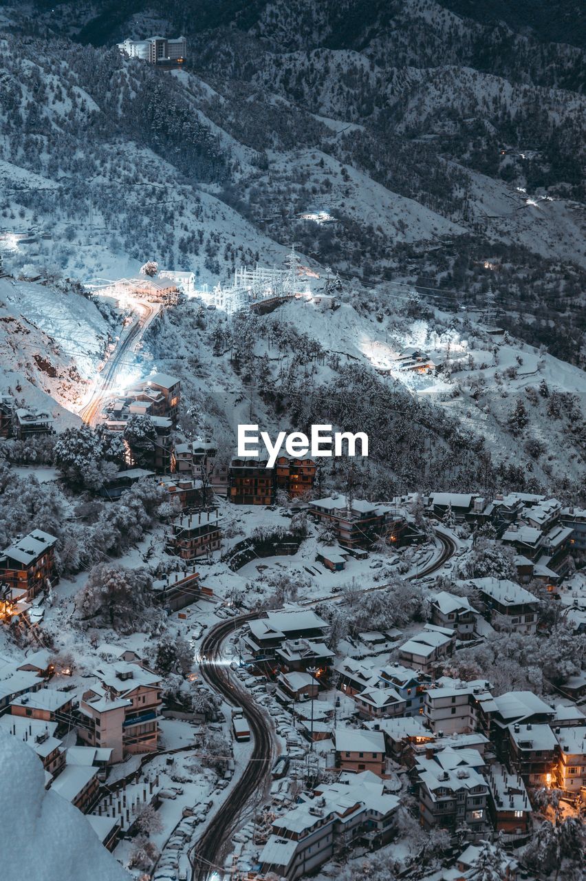 High angle view of road amidst buildings in city during winter