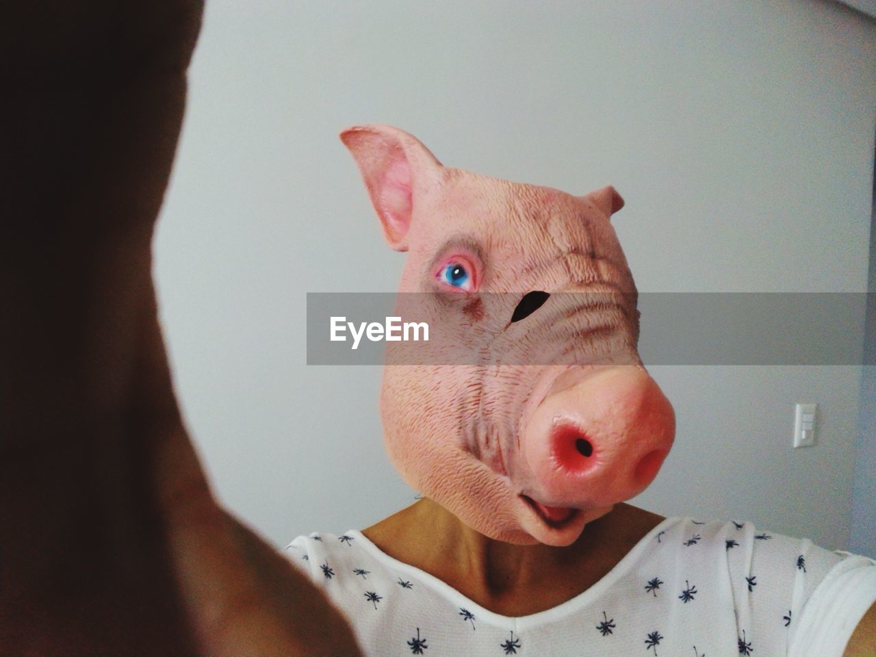 Woman wearing mask with pig head shape