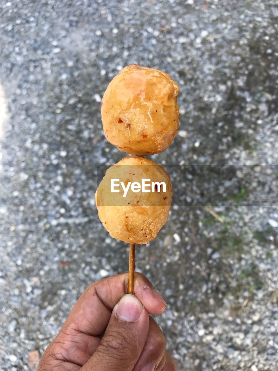 CLOSE-UP OF HAND HOLDING FOOD