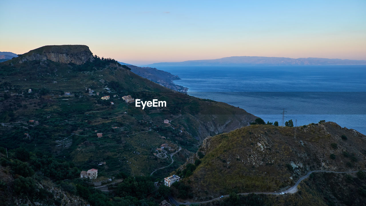 High angle view of mountains and river against sky