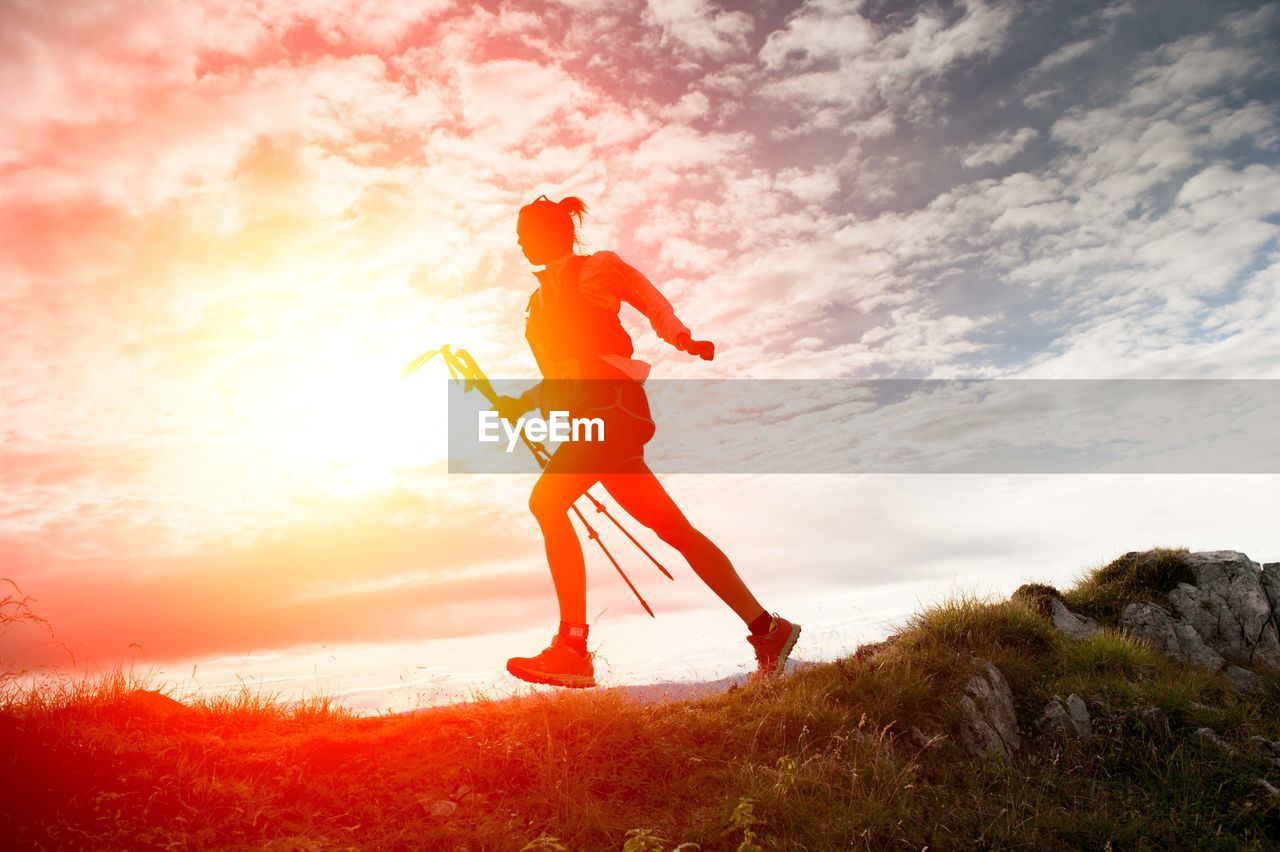 Full length of man jumping against sky