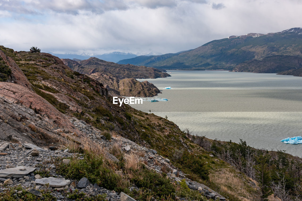 Scenic view of sea and mountains against sky